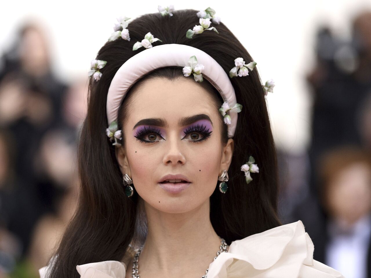Lily Collins wears lavender eyeshadow and a bouffant at the 2019 Met Gala.