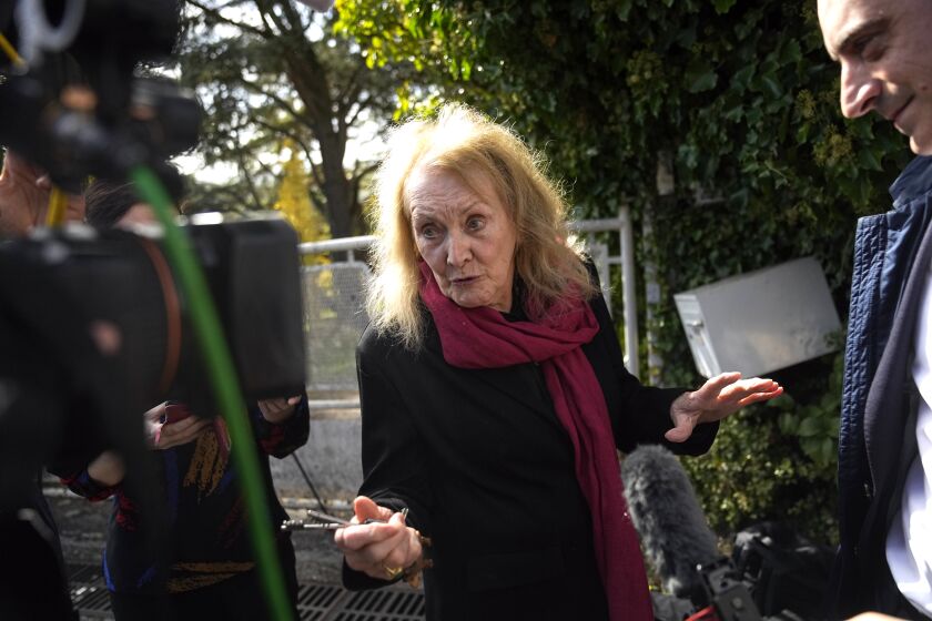 French author Annie Ernaux adresses to media outside her home in Cergy-Pontoise, outside Paris, Thursday, Oct. 6, 2022.