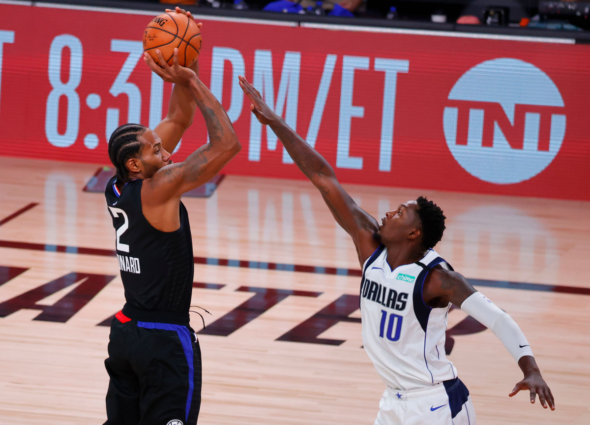 Clippers forward Kawhi Leonard shoots over Dallas Mavericks forward Dorian Finney-Smith.
