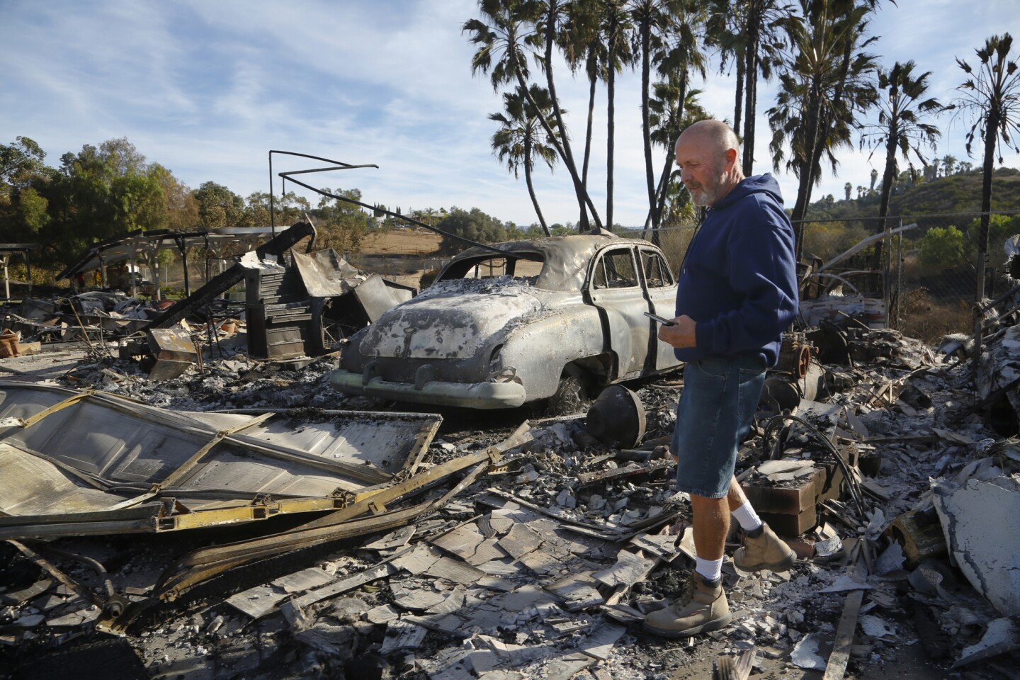 Mike Hulsizer returned to his home in Bonsall for the first time since Thursday's fire. Hulsizer walked around the burned debris of what use to be his garage and where his restored 1949 Oldsmobile was parked.