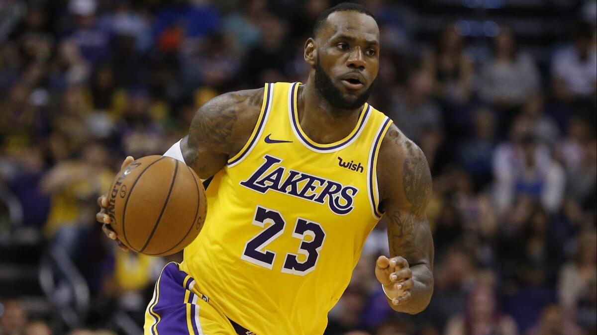 Lakers forward LeBron James controls the ball in the second half against the Phoenix Suns on March 2 in Phoenix.