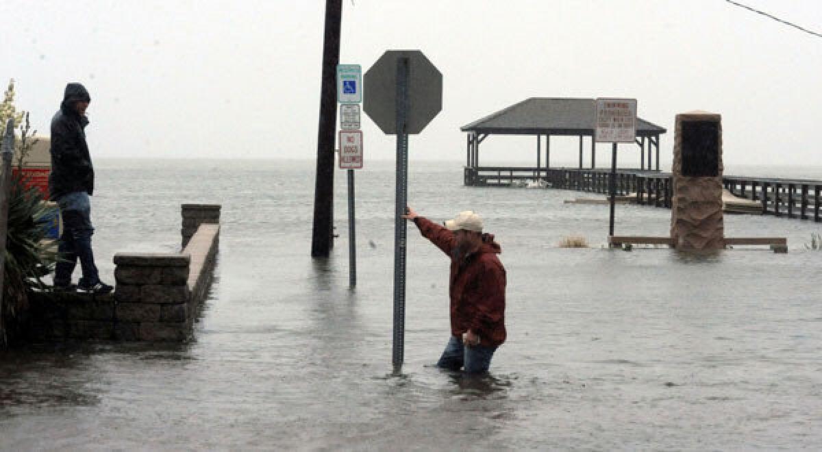 Bobby Huggins, of Millville, and his cousin, Brian Cuthbert, of Somers Point, see how deep the water is at Bay Avenue and New Jersey Avenue in Somers Point, N.J.