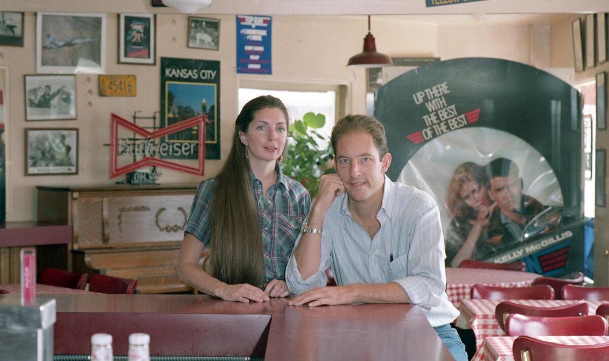 Cindy and Martin Blair sit at the bar in their Kansas City Barbeque restaurant