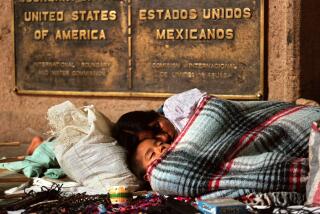 08/22/1998 -- Mother and son sleeping at the San Ysidro border crossing. (John Gastaldo / Union-Tribune)