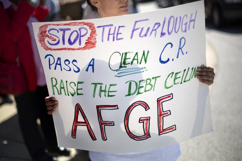 Andrea Bentley, with the American Federation of Government Employees, was among demonstrators protesting the government shutdown outside the Centers for Disease Control and Prevention in Atlanta.