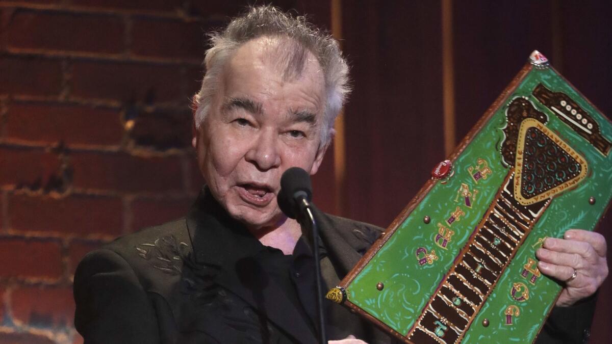Veteran singer-songwriter John Prine, shown accepting the Americana Music Assn.'s artist of the year award last week in Nashville, is part of an Oct. 19 concert in L.A. jointly benefiting the Americana group and the Blues Foundation.