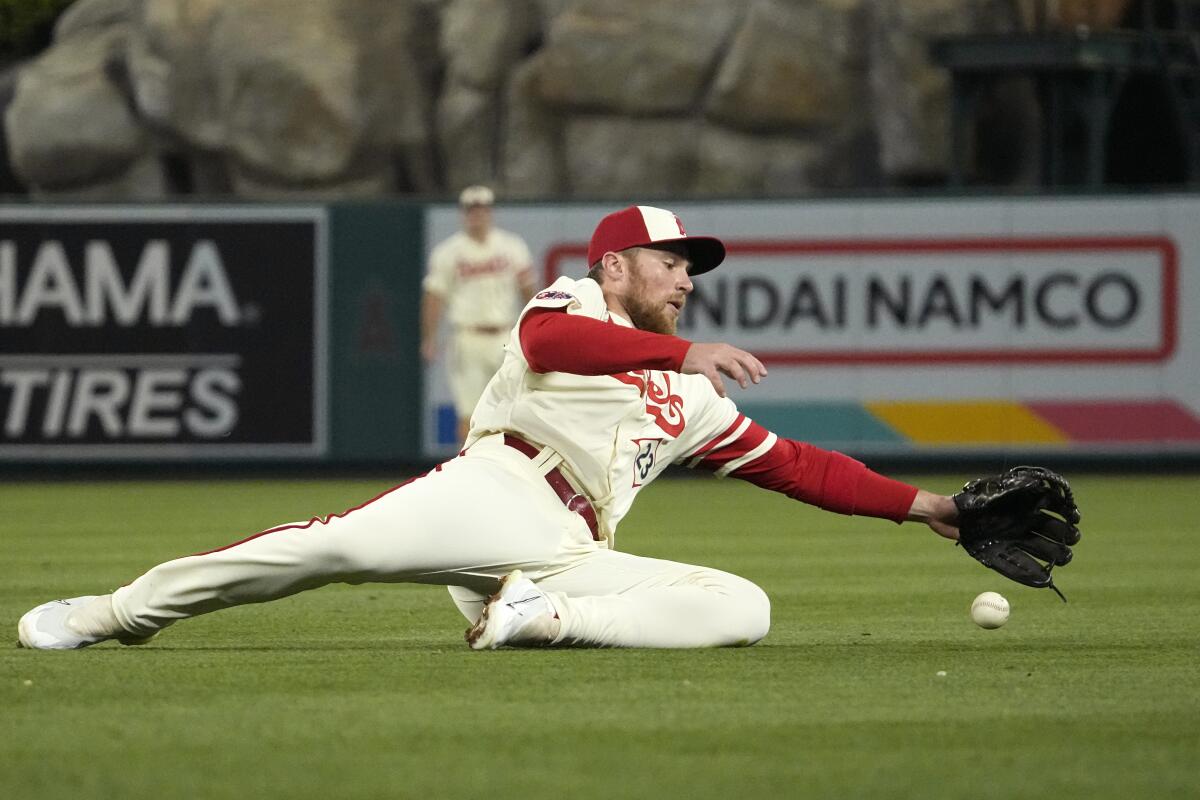 Angels second baseman Brandon Drury makes stop on a ball hit for a single by Oakland Athletics' Esteury Ruiz.