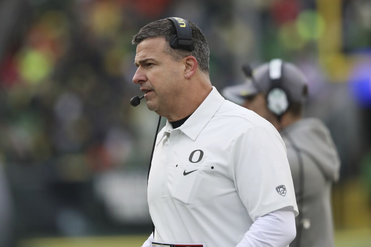 Oregon coach Mario Cristobal watches from the sideline during a game.
