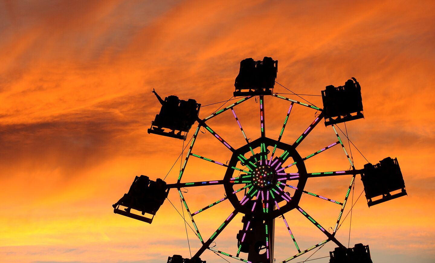As the sun sets, people enjoy a carnival ride during the Electric Daisy Carnival in Las Vegas on June 17.