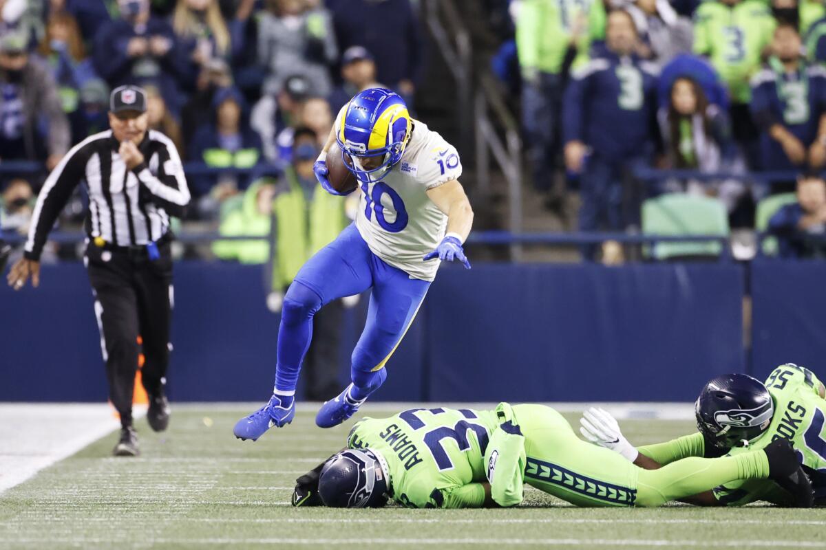 Los Angeles Rams wide receiver Cooper Kupp leaps over Seattle Seahawks safety Jamal Adams (33) during the second half of an NFL football game, Thursday, Oct. 7, 2021, in Seattle. The Rams won 26-17. (AP Photo/Craig Mitchelldyer)