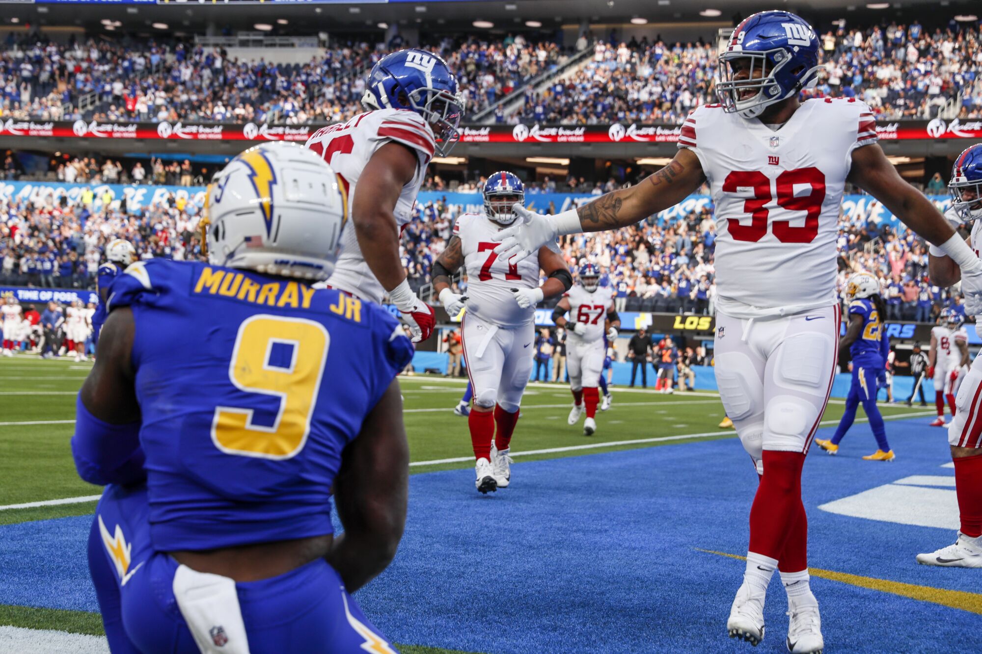 New York Giants running back Elijhaa Penny celebrates after beating Chargers middle linebacker Kenneth Murray.