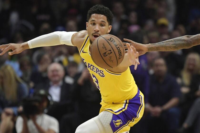 Los Angeles Lakers guard Josh Hart, left, and Los Angeles Clippers guard Lou Williams reach for a loose ball during the first half of an NBA basketball game Thursday, Jan. 31, 2019, in Los Angeles. (AP Photo/Mark J. Terrill)