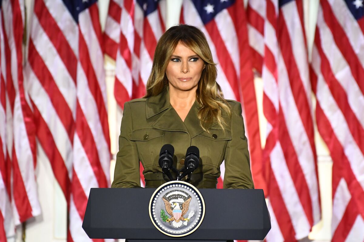Melania Trump addresses the Republican convention from a podium outside the White House; American flags hang behind her.