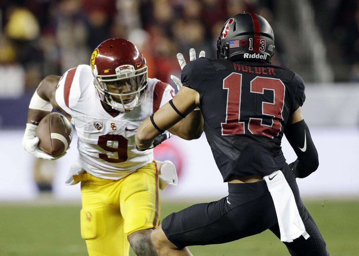 USC receiver JuJu Smith-Schuster straight-arms Stanford cornerback Alijah Holder in the Pac-12 championship Dec. 5.