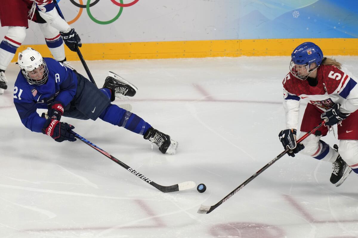 U.S. forward Hilary Knight, left, dives for the puck in front of the Czech Republic's Samantha Ahn Kolowratova.