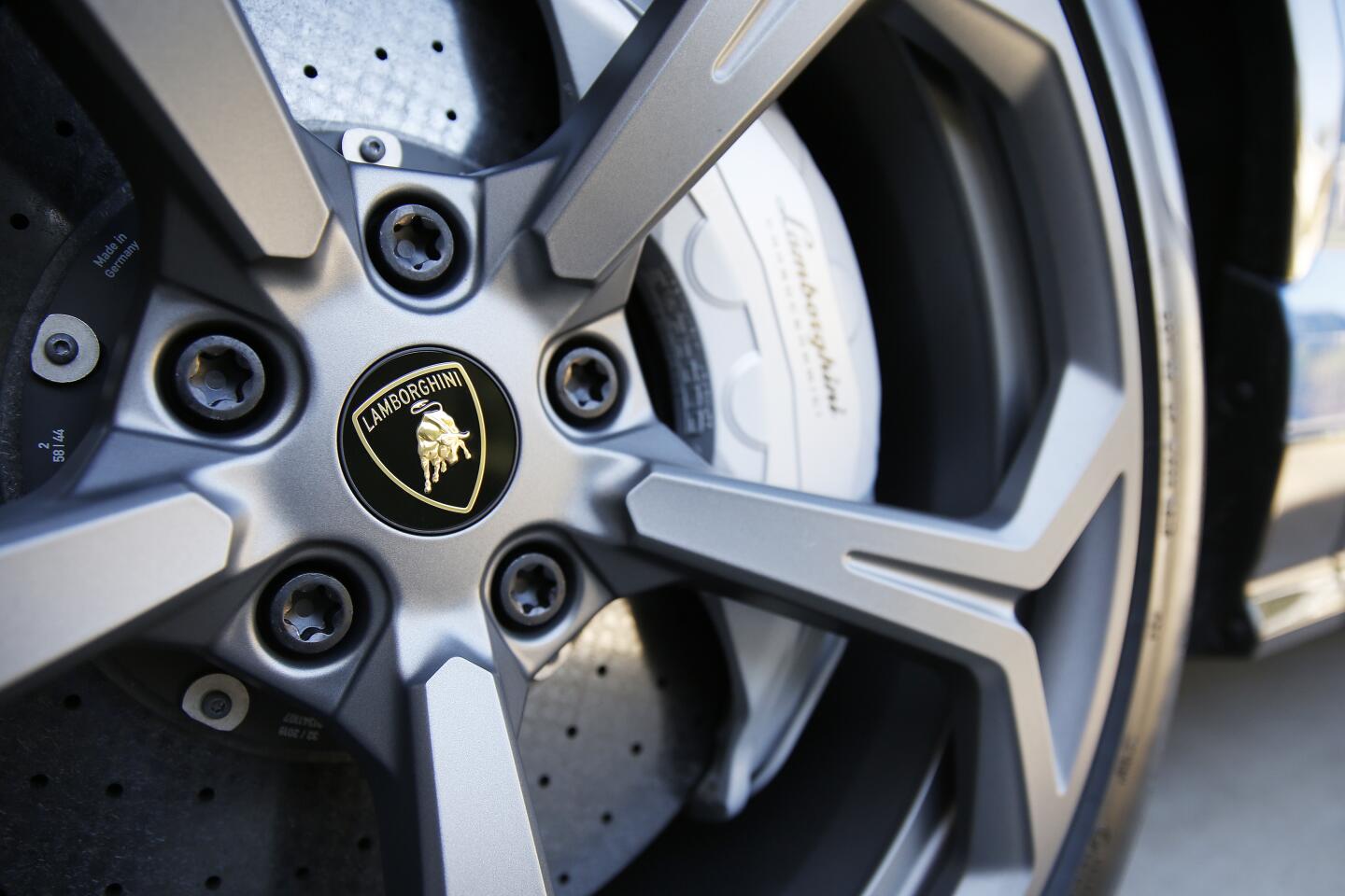 A tire with the Lamborghini logo in the center of the hubcap.