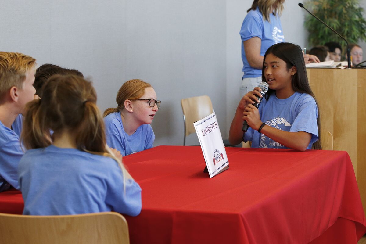 Eastbluff 2 fifth-grader Morgan Pham, right, gives her team's answer.