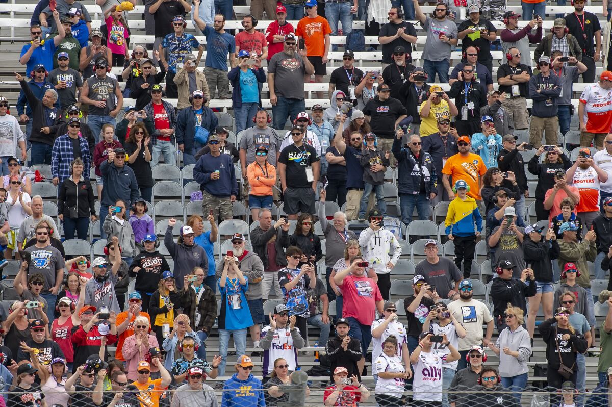 Fans watch from the stands at the NASCAR Cup Series auto race at Dover Motor Speedway, Monday, May 2, 2022, in Dover, Del. (AP Photo/Jason Minto)