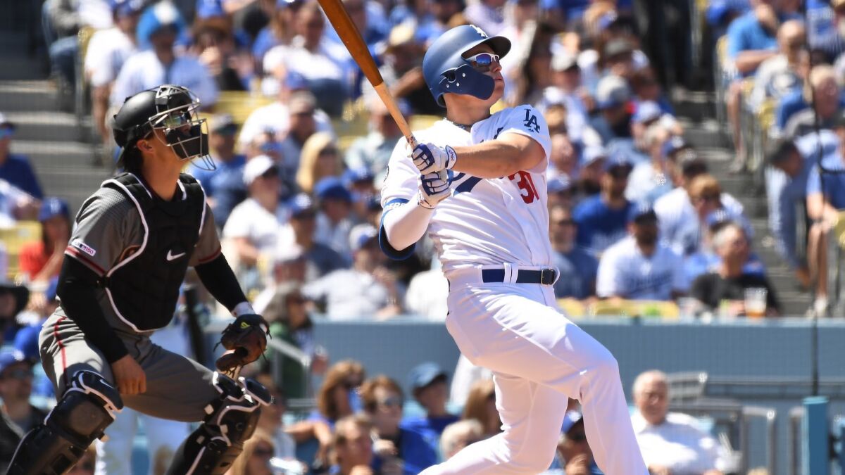 Dodgers left fielder Joc Pederson hits a two-run home run during the second inning of Thursday's game against the Diamondbacks.