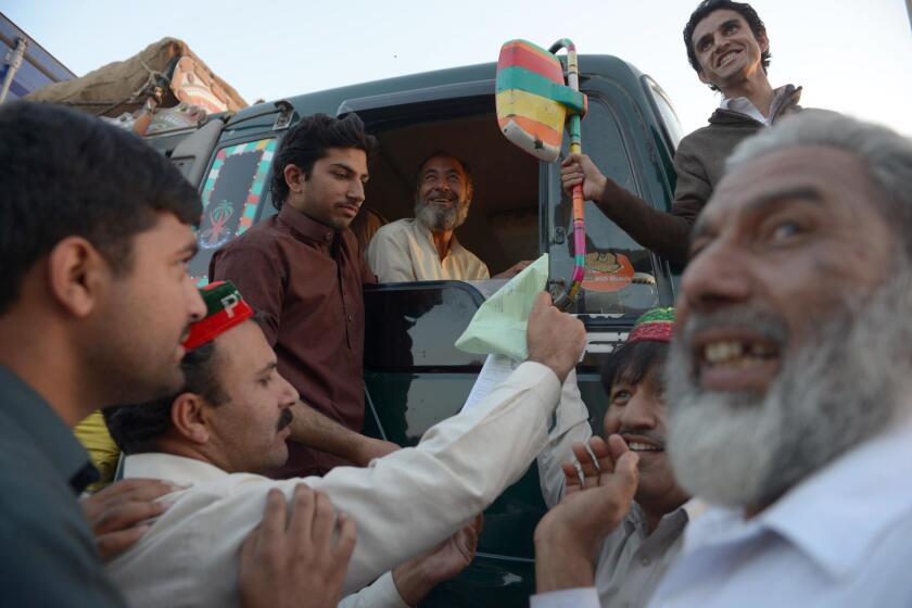 Anti-drone activists stop a truck to check its documents at a protest camp targeting NATO shipments through Peshawar, Pakistan.