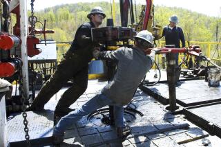 FILE - Workers move a section of well casing into place at a Chesapeake Energy natural gas well site near Burlington, Pa., in Bradford County, on April 23, 2010. (AP Photo/Ralph Wilson, File)