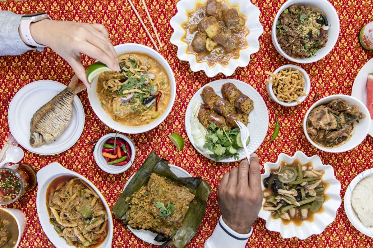 Specialties at Northern Thai Food Club include khao soi (being squeezed with lime), sai ua (pork sausages) and an ever-changing selection of stews from the steam table.