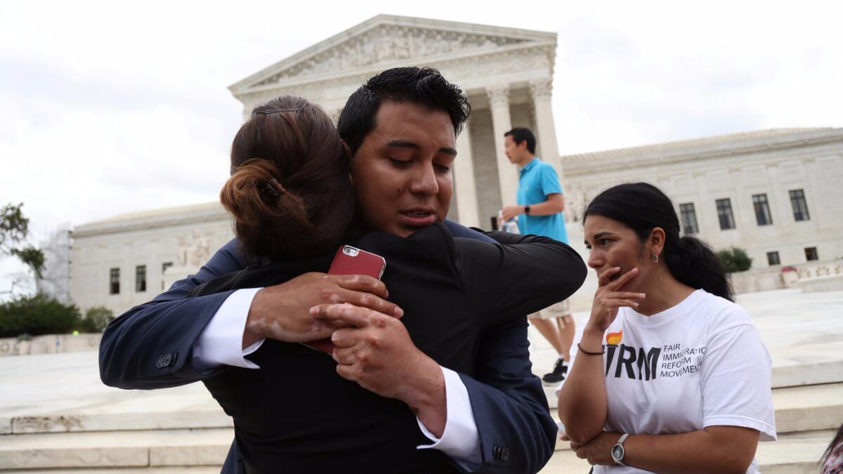 Immigration supporters react outside the U.S. Supreme Court after the justices issued a split ruling on President Obama's immigration policy Thursday.
