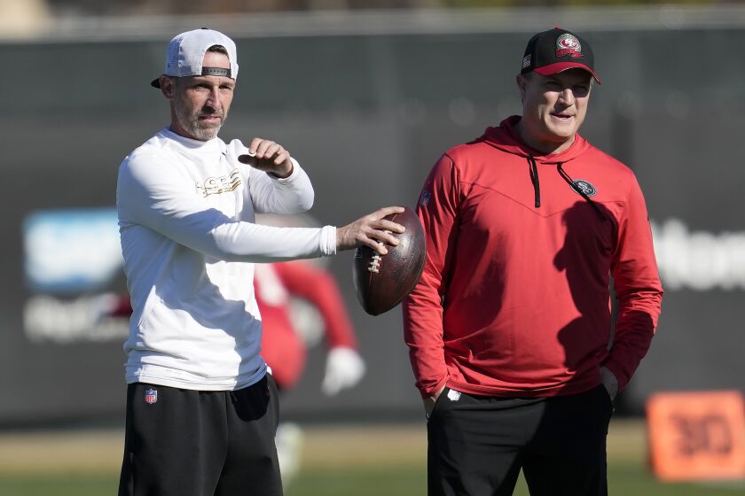San Francisco 49ers head coach Kyle Shanahan, left, and general manager John Lynch watch as players take part in drills during an NFL football practice in Santa Clara, Calif., Thursday, Jan. 26, 2023. The 49ers are scheduled to play the Philadelphia Eagles Sunday in the NFC championship game. (AP Photo/Jeff Chiu)