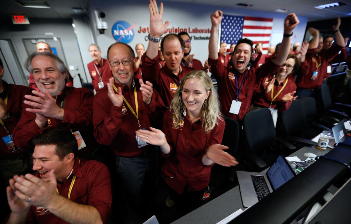 NASA engineers at the Jet Propulsion Laboratory celebrate the landing.