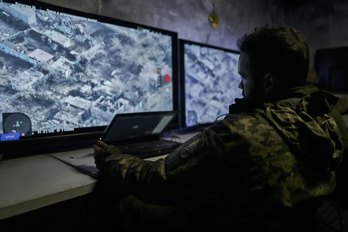 A Ukrainian soldier watches a drone feed from an underground command center.