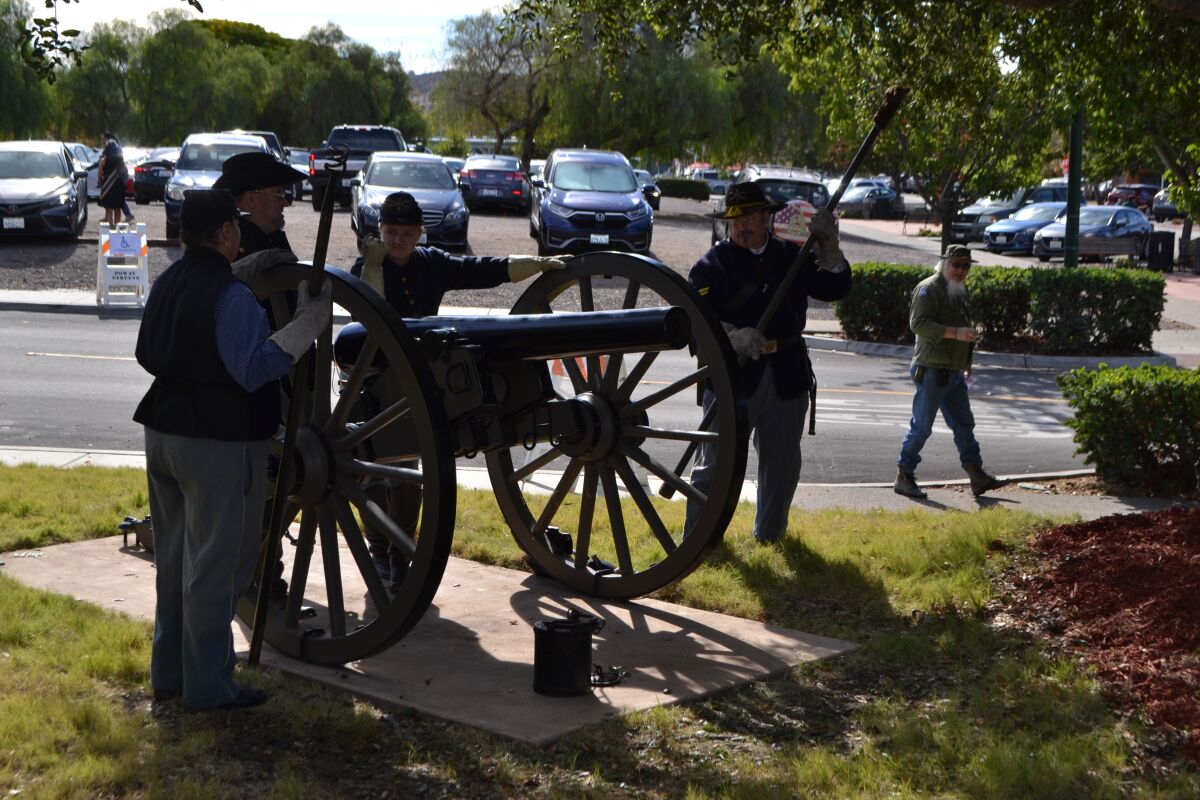 A crew readies the cannon for firing at Veterans Park in Poway.