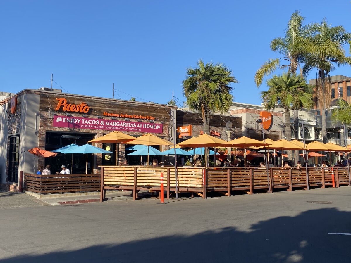 Customers eat outdoors at Puesto on Wall Street in La Jolla on Nov. 13.