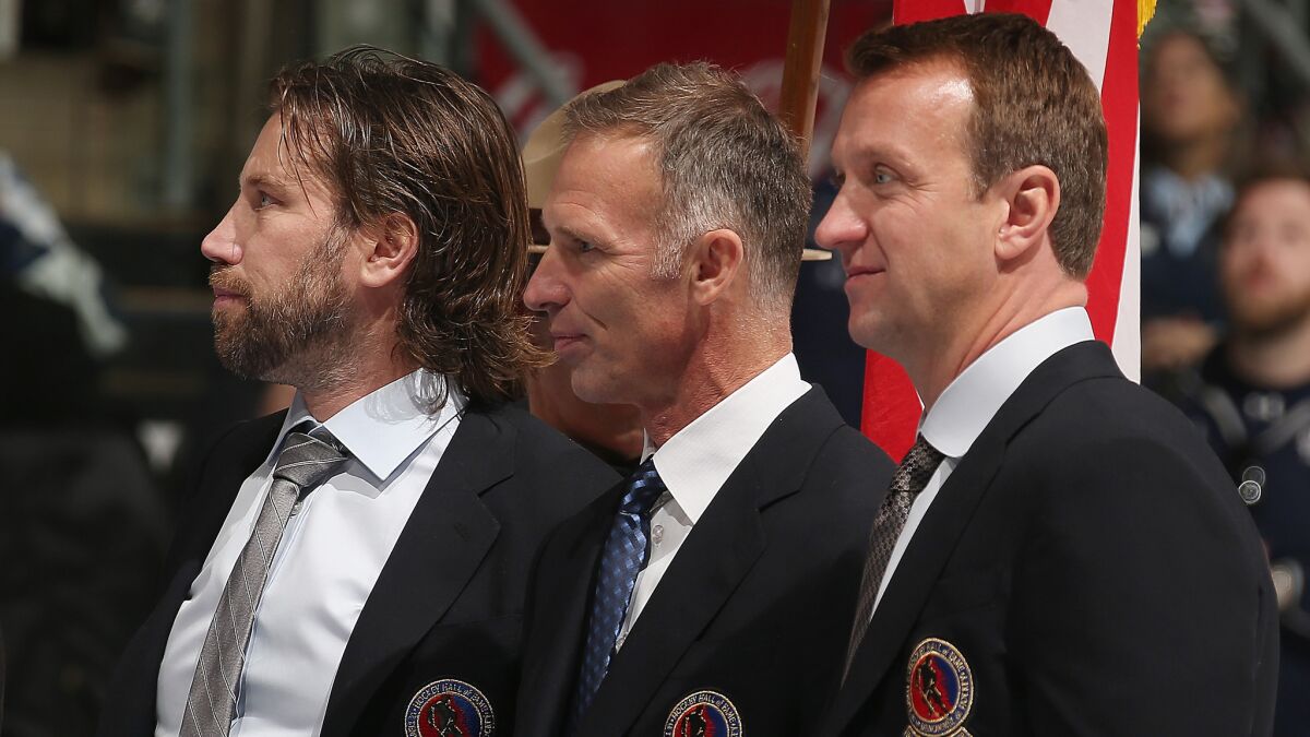 Hockey Hall of Fame inductees (from left to right) Peter Forsberg, Dominik Hasek and Rob Blake take part in the blazer presentation before the legends game in Toronto on Sunday.