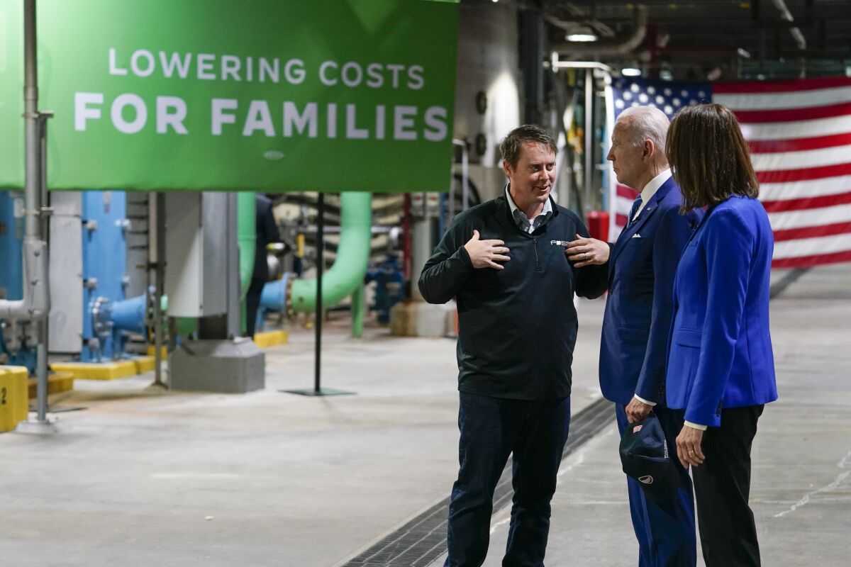 President Joe Biden and Rep. Cindy Axne, D-Iowa, talk with Jack Mitchell, regional vice president of POET Bioprocessing, left, as he gives them a tour at POET Bioprocessing in Menlo, Iowa, Tuesday, April 12, 2022. (AP Photo/Carolyn Kaster)