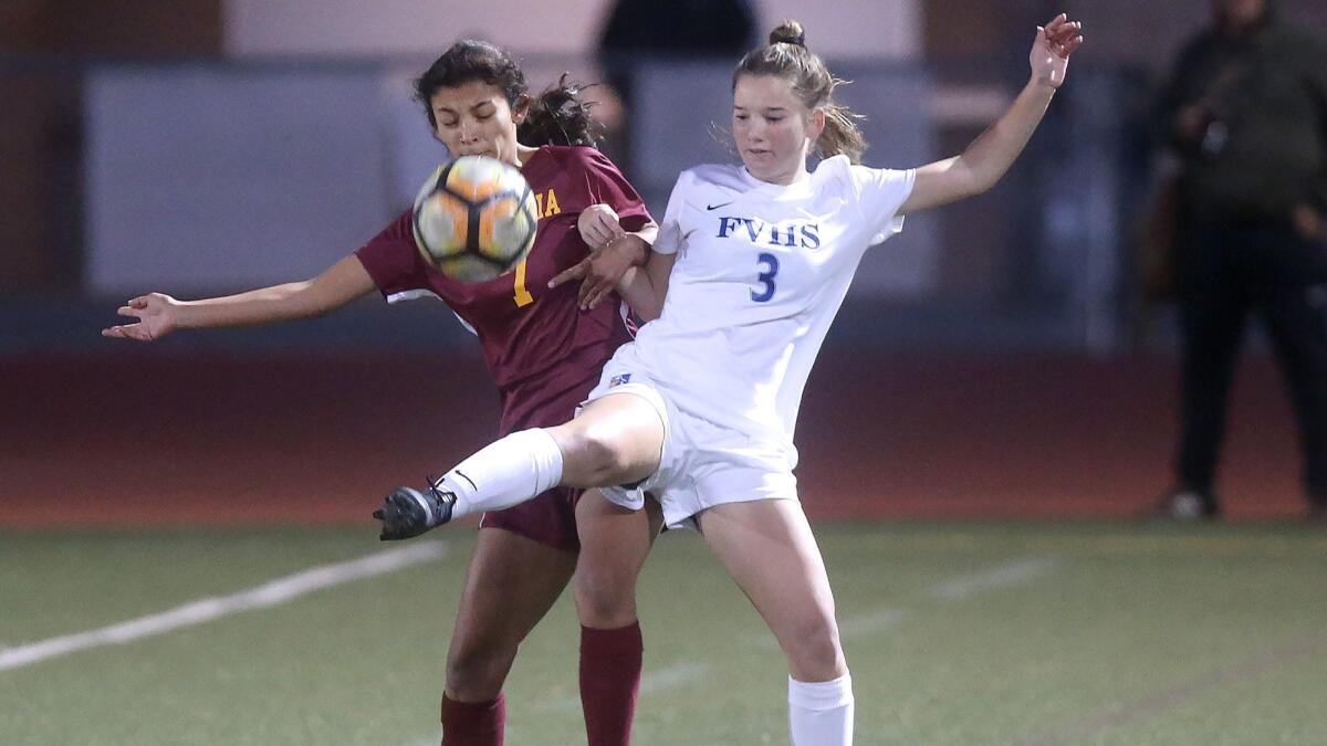 Fountain Valley High's Zoe La Clair (3) controls the ball in front of Estancia's Paulina Cortez during a girls' nonleague soccer game on Tuesday. Fountain Valley won 1-0 with a second-half goal by junior forward Summer Khalil.