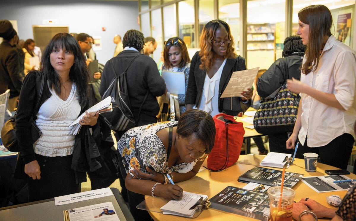 People attend a jobs fair at the Bronx Public Library in New York. February was the 12th straight month in which the economy added more than 200,000 net new jobs, the best streak since 1994-95.