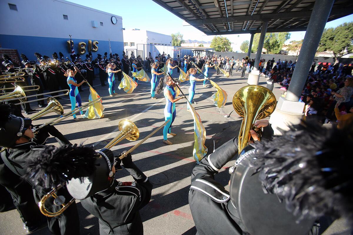 The Glendale High School marching band and color guard perform at Marshall Elementary School on Monday. The school won a California Positive Behavioral Interventions and Supports gold medal and celebrated the recognition in the quad with the entire school along with members of the Glendale Unified School Board.