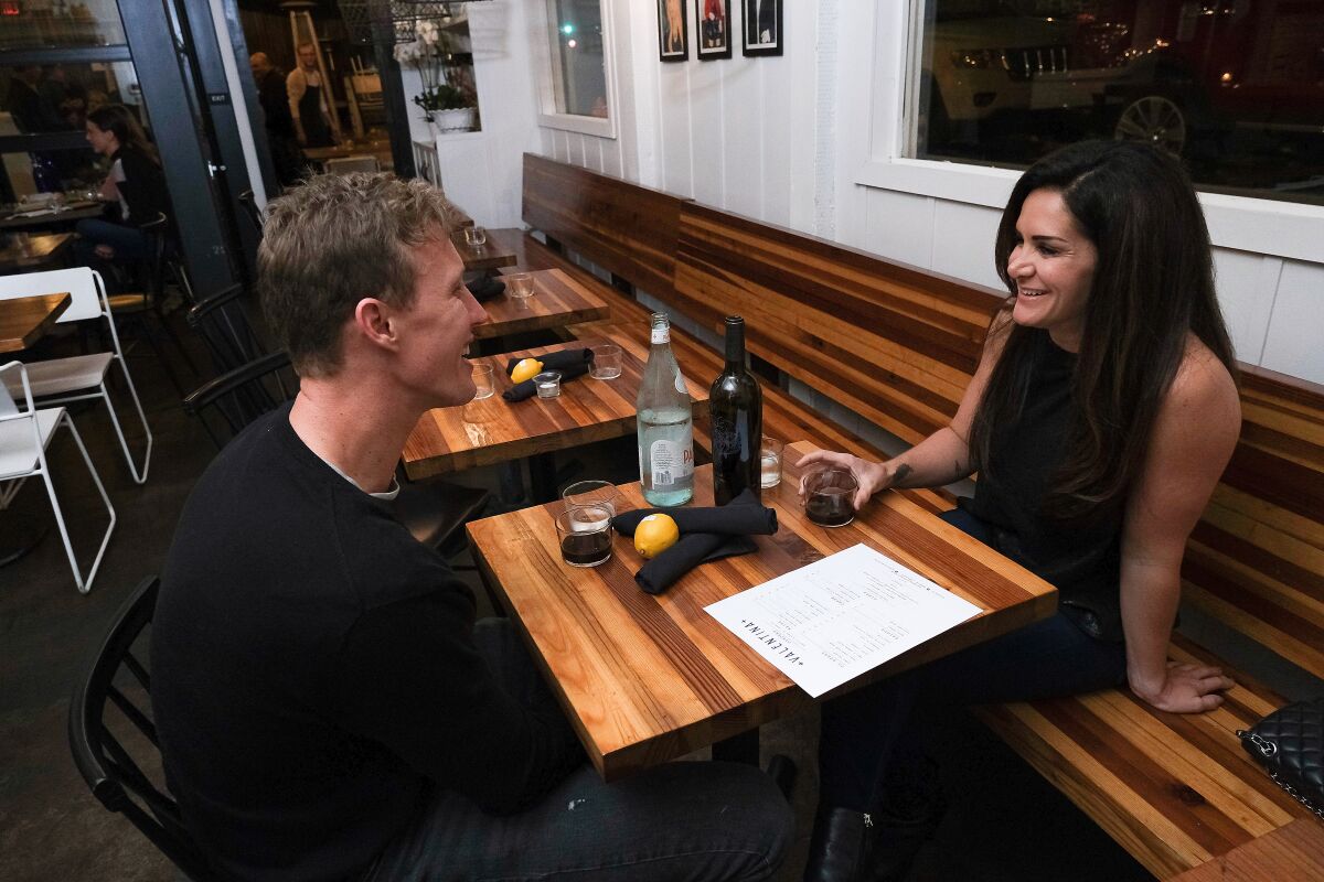 Carina and David start up a conversation as they wait for their diner at Valentina in Encinitas.