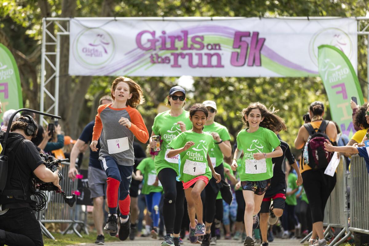Children and adults participate in a Girls on the Run 5K