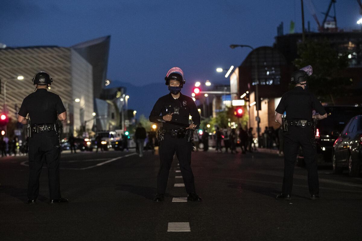 A line of LAPD officers downtown at night