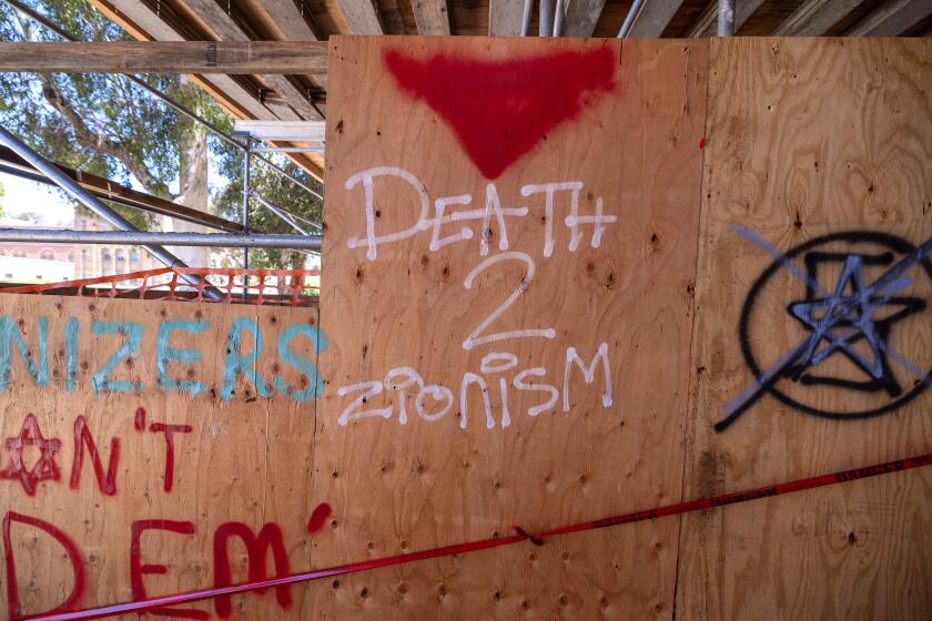 Graffiti at the Powell Library on the UCLA campus where pro-Palestinian demonstrators erected an encampment in Dickson Plaza on on Monday, April 29, 2024 in Los Angeles, CA. (Brian van der Brug / Los Angeles Times)