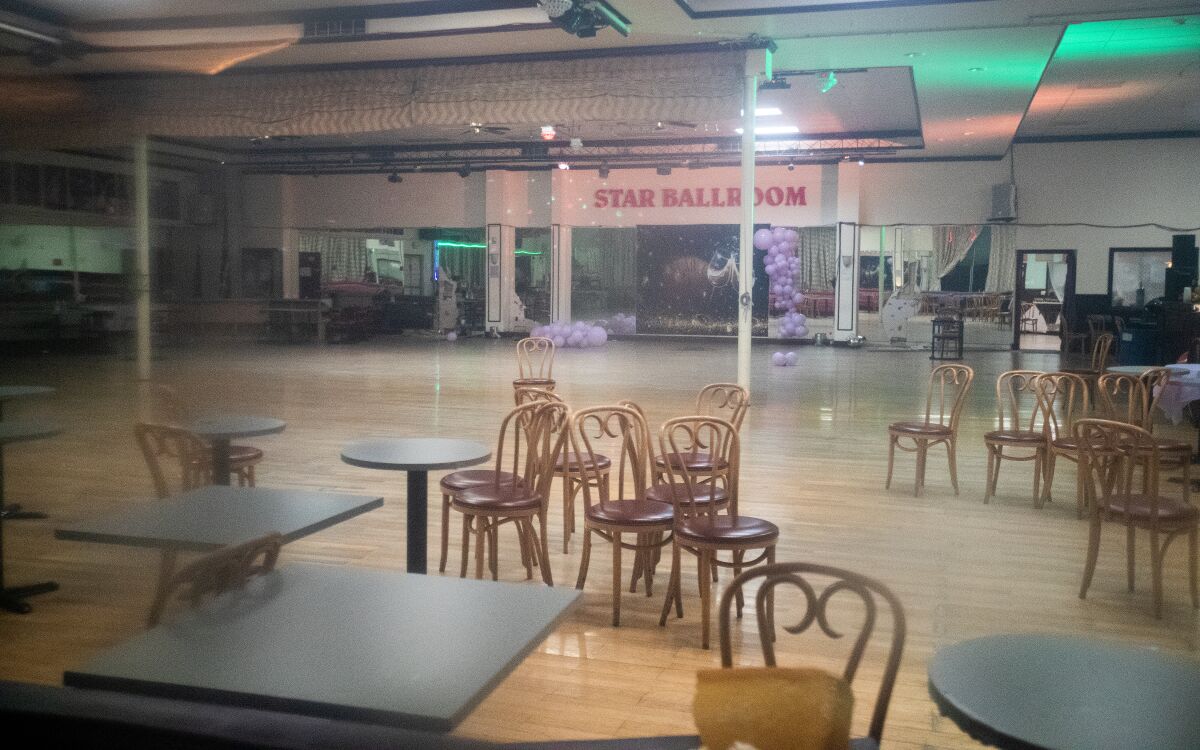 An empty dance studio with tables and chairs