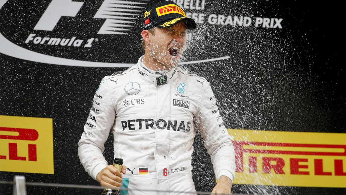 Formula One driver Nico Rosberg is sprayed with champagne after winning the Chinese Grand Prix on Sunday in Shanghai.