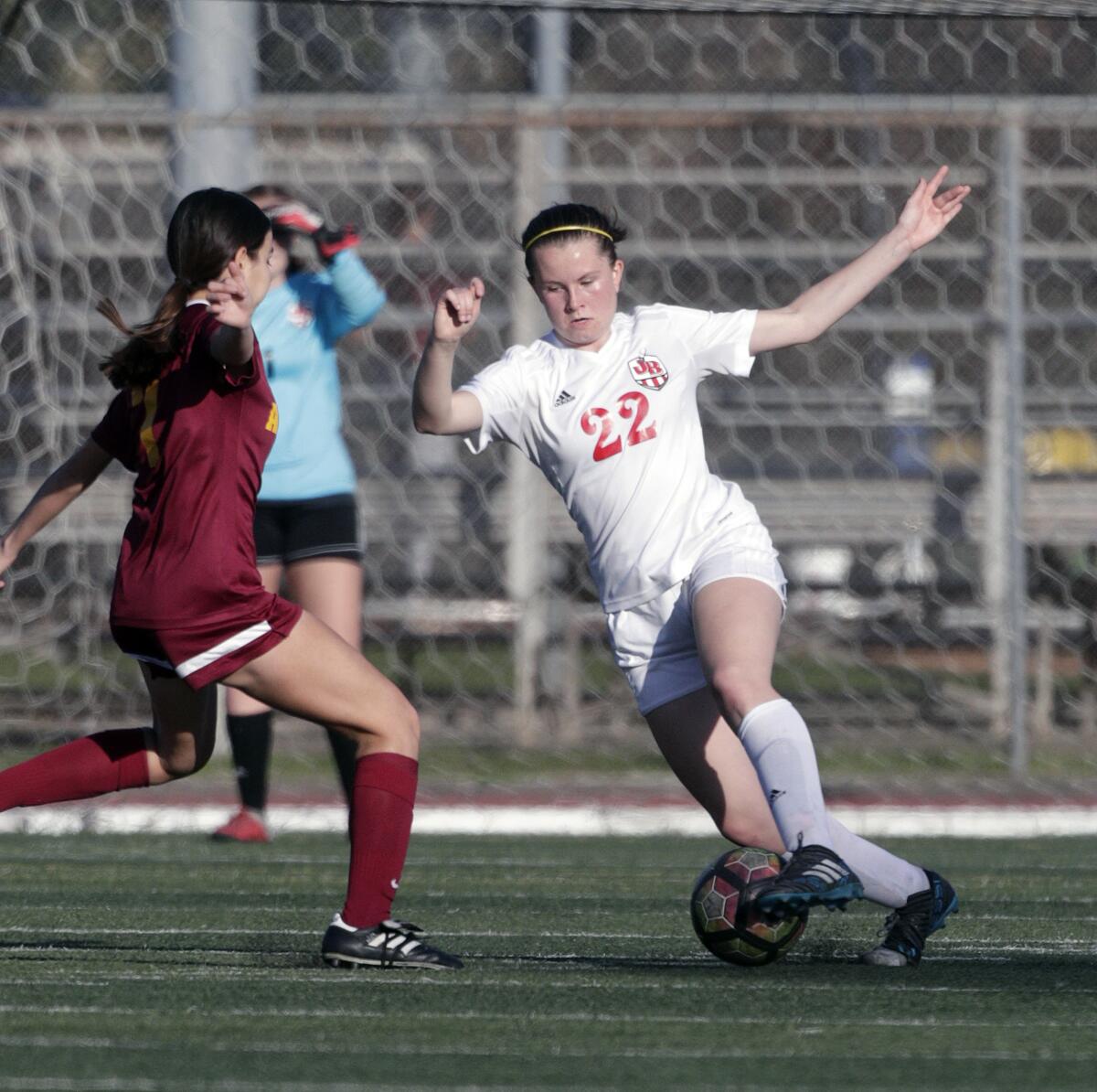 Burroughs' Maille Romberger cuts the other direction against Arcadia's Bertha Guzman in a Pacific League girls' soccer game at Arcadia High School in Arcadia on Tuesday, January 28, 2020.