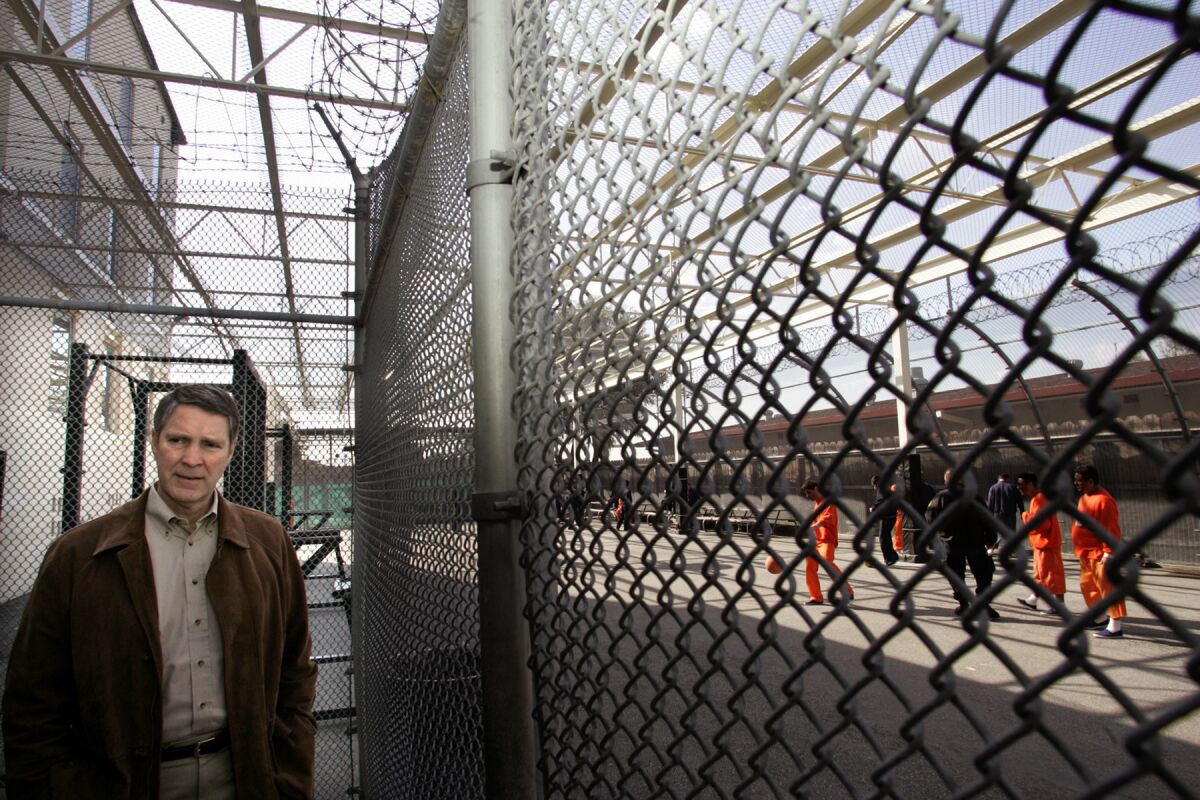 Former U.S. Senate Majority Leader Bill Frist, R-Tenn., stands next to a recreation area for immigrant detainees, while touring the San Pedro Service Processing Center on Terminal Island in Los Angeles on February 21, 2006.