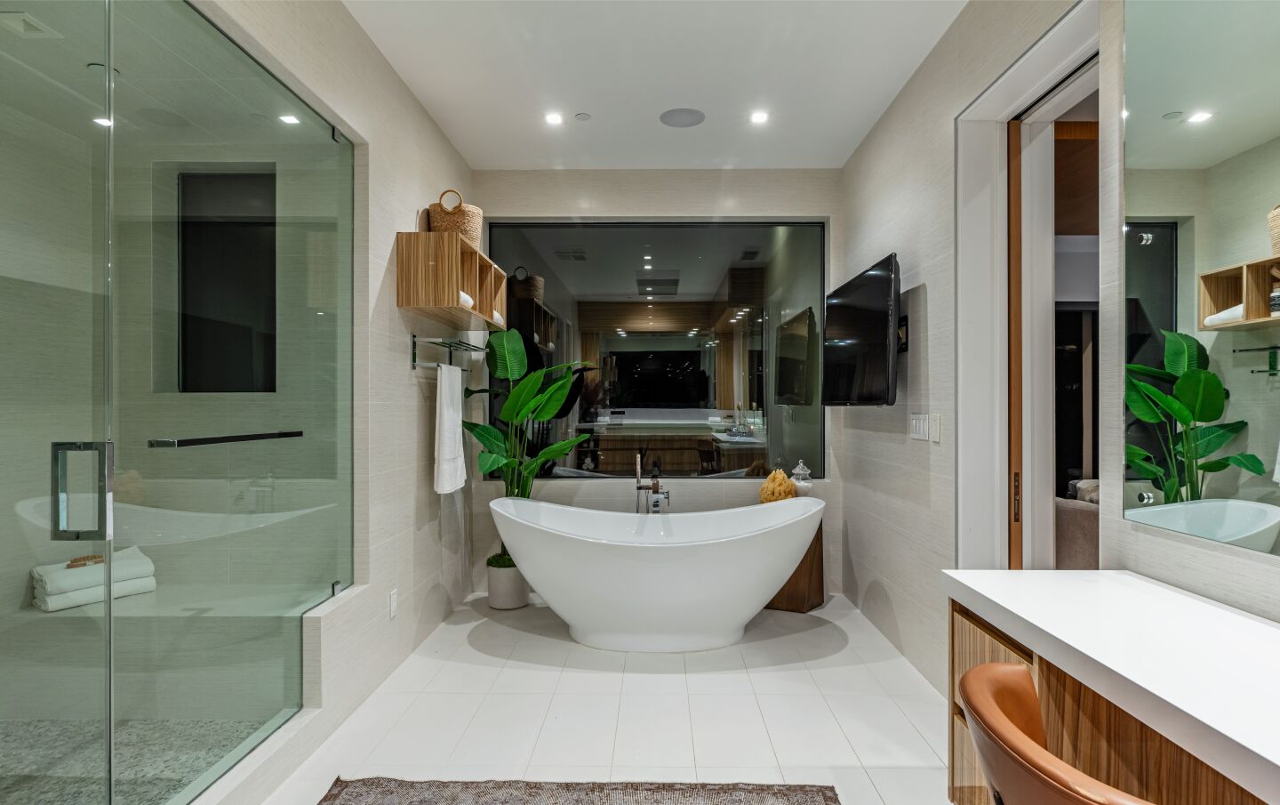 The bathroom has a shower and a tub and counter.