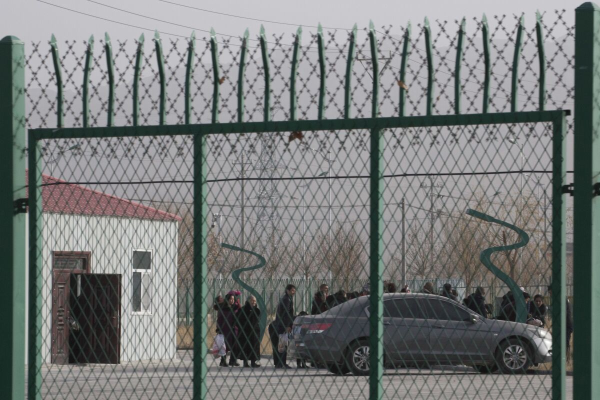 Residents line up inside a forced indoctrination camp in western China's Xinjiang region in December 2018.
