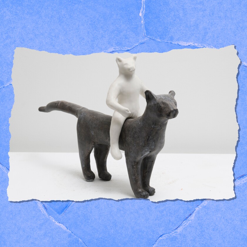 The figure of a bear sits upright on the back of a panther-like figure.