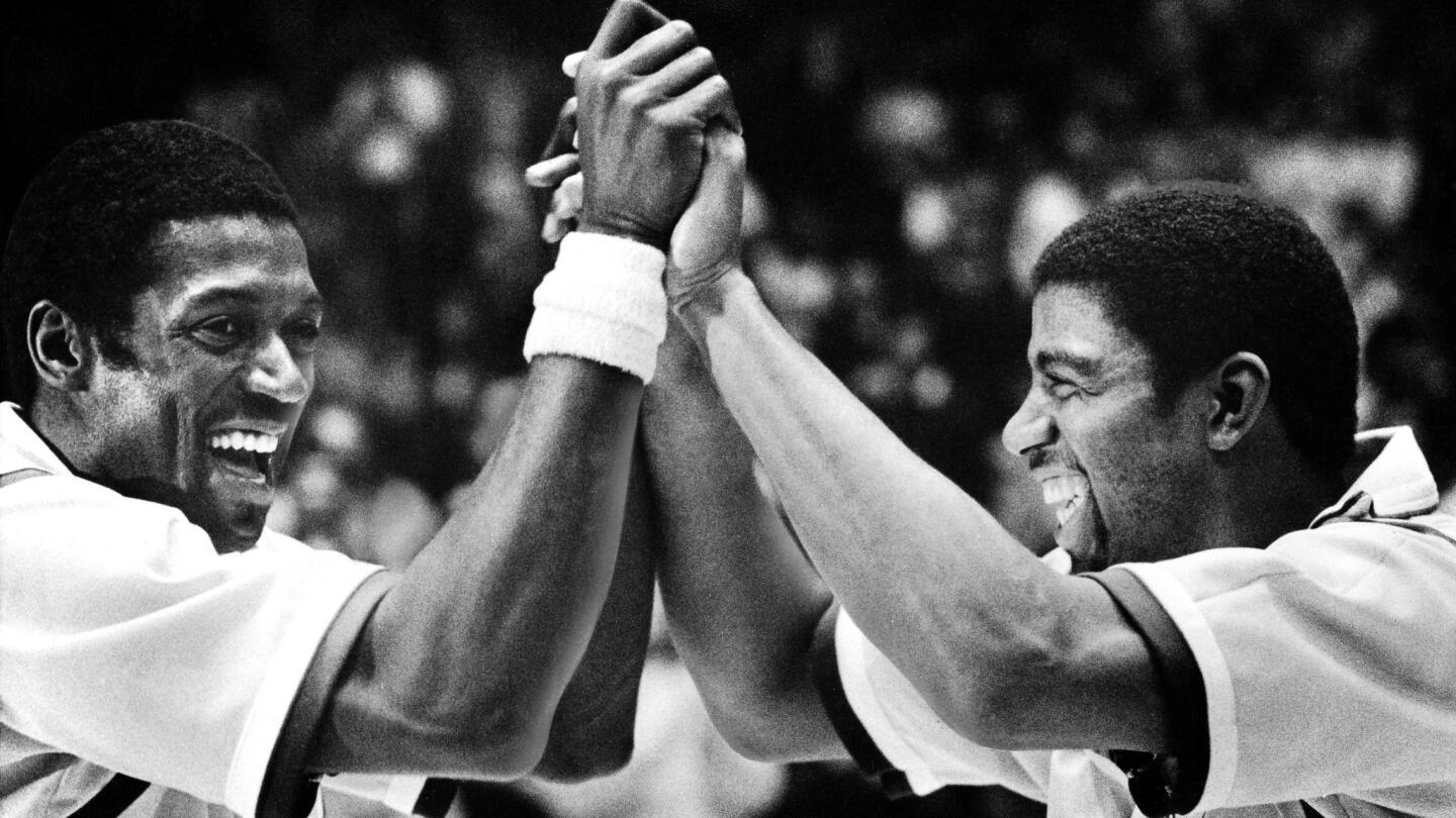 Jim Brewer greets Johnson upon his return to the Lakers' lineup on Feb. 27, 1981, at the Forum against the New Jersey Nets.