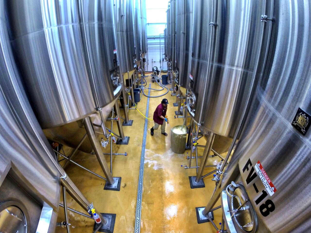 Cellarman Tony Chacon works on tank prep in the brewhouse at Brew Hub, the new state-of-the-art, 50,000-square-foot beer brewing co-op, in Lakeland, Fla. Wednesday, March 11, 2015. (Joe Burbank/Orlando Sentinel) B584463658Z.1
